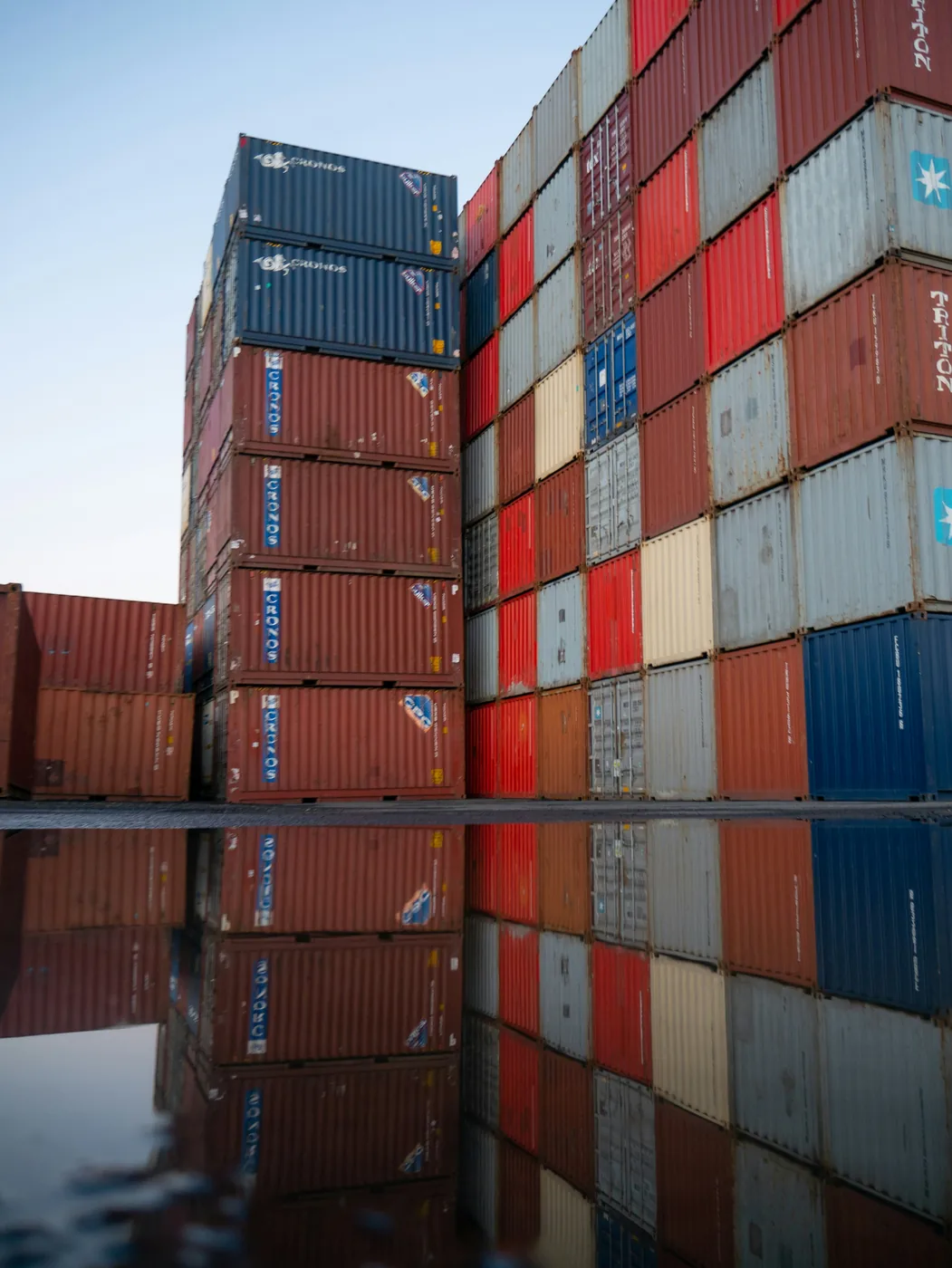 Stacked intermodal shipping containers in a Huntsville, Alabama freight yard — FTL, LTL, and drayage transportation services for North Alabama shippers